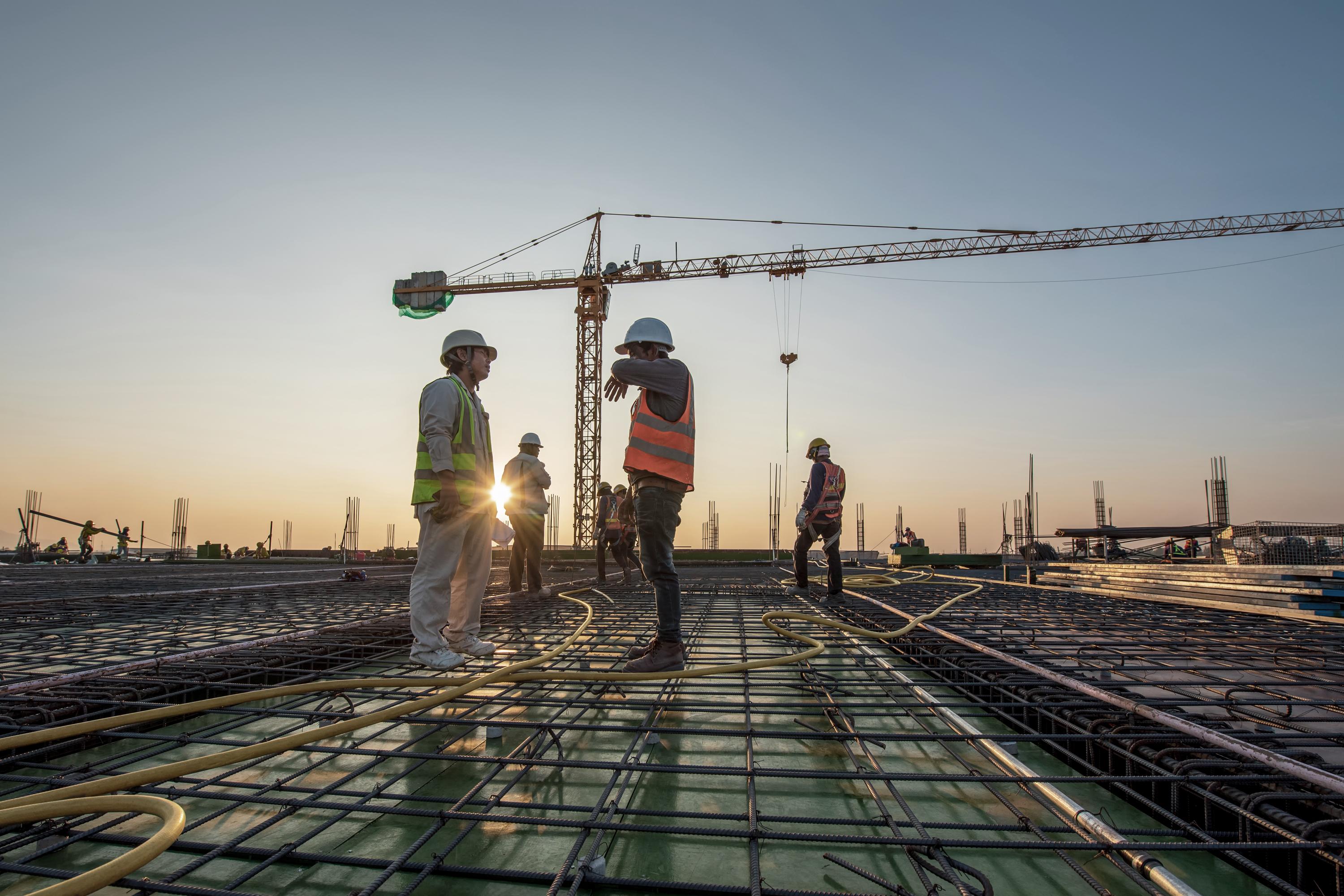 Workers on rooftop with sun behind them