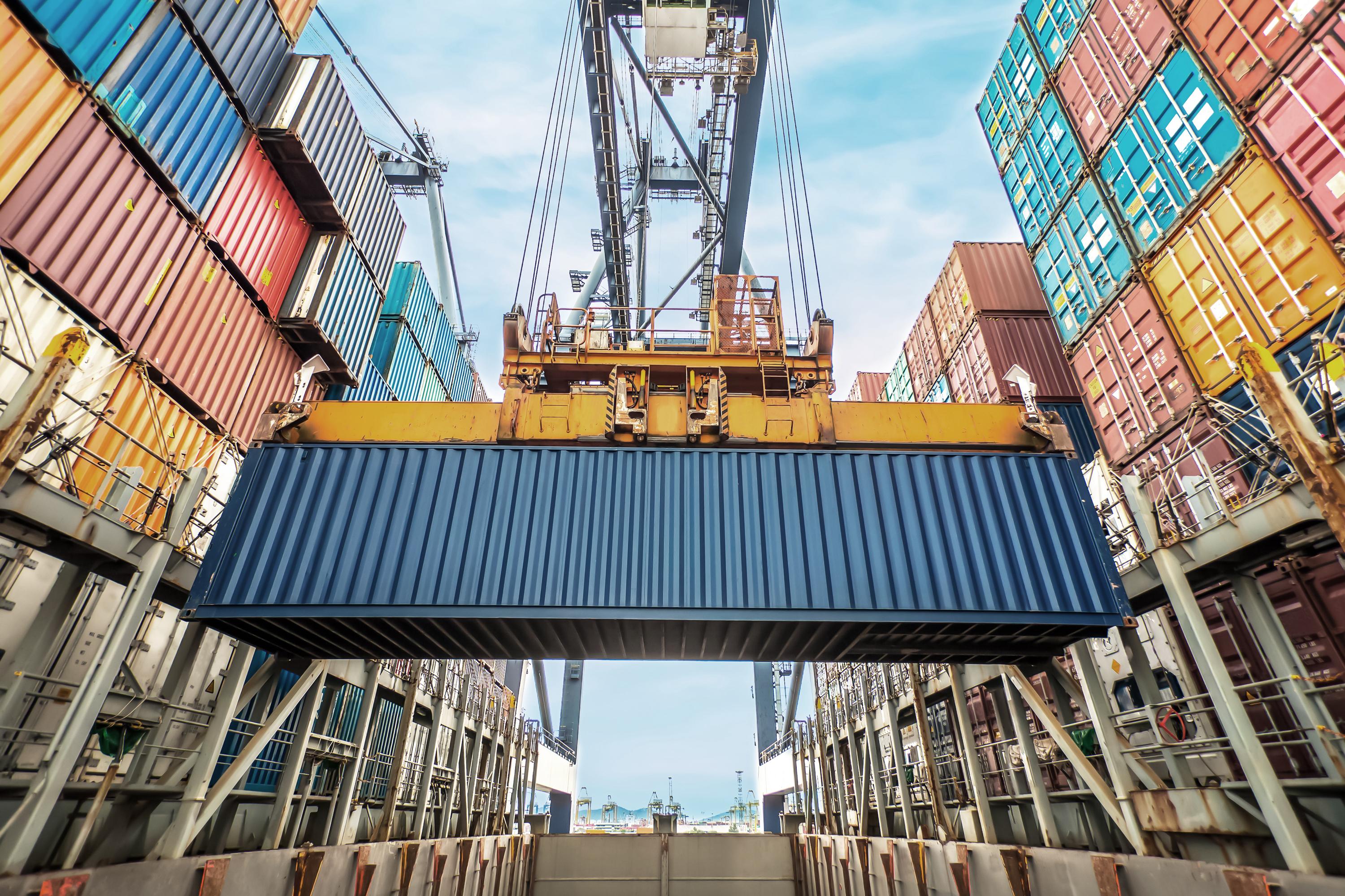 Offloading shipping containers with blue container in image