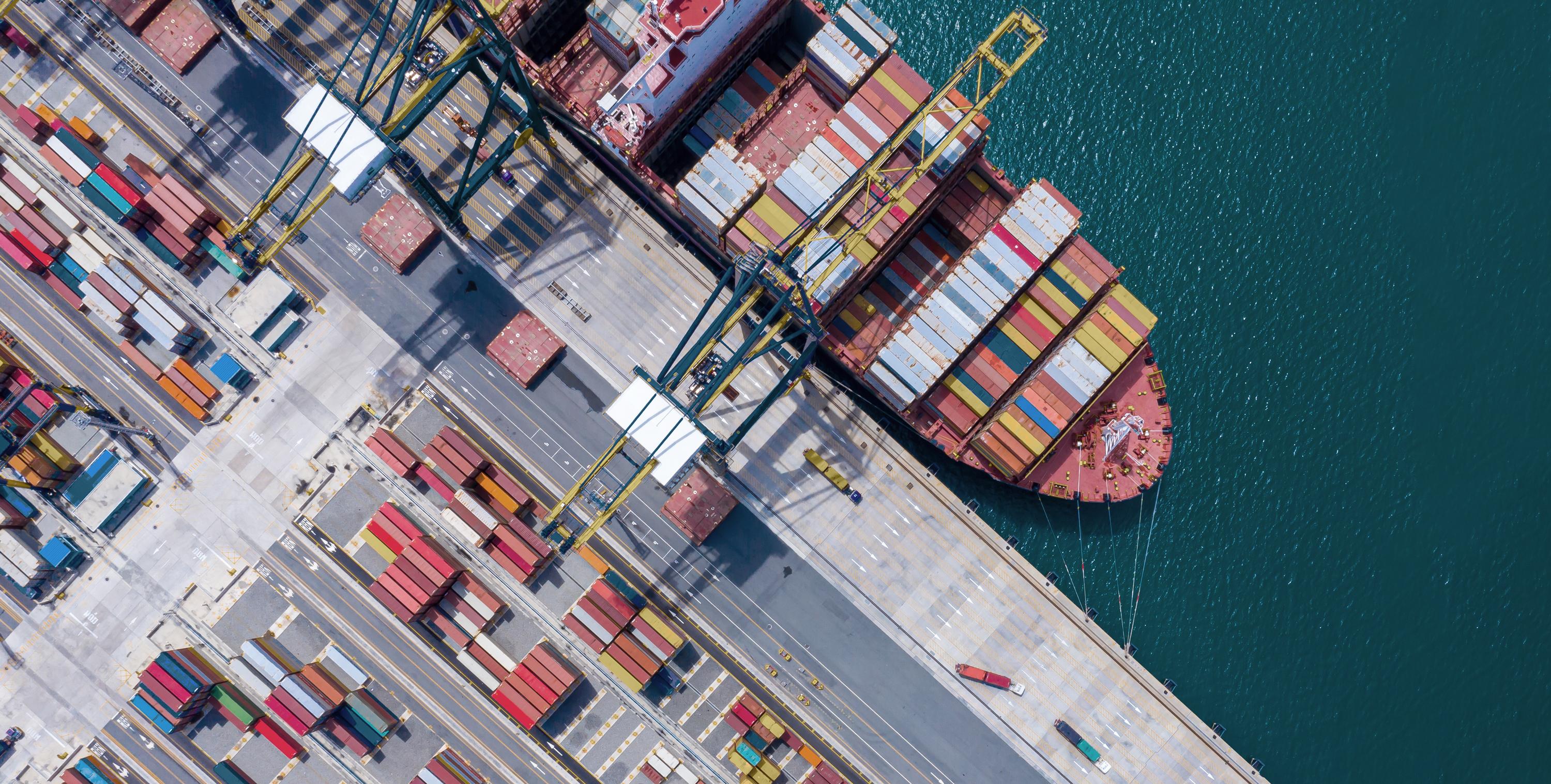 Arial shot of a shipping harbour with ship on the sea